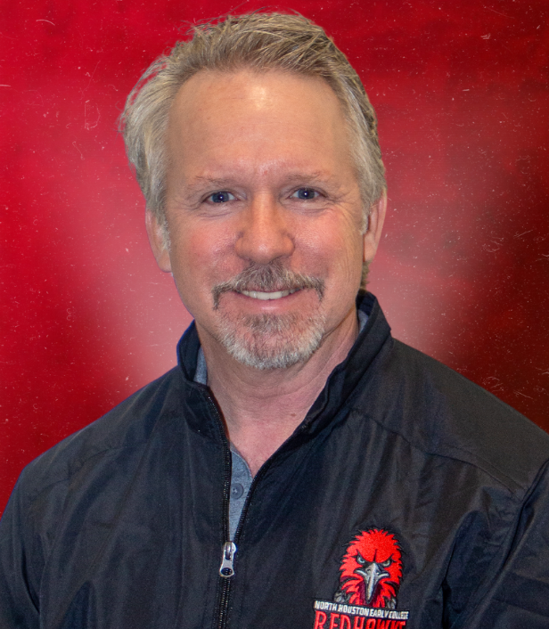 A person with a mustache and a black jacketDescription automatically generated